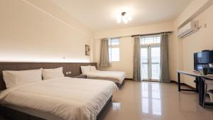 A bed or beds in a room at Yearning Homestay