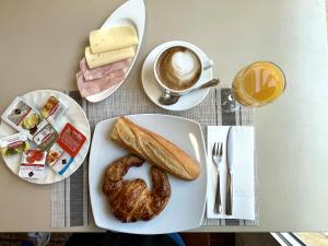 a table with a plate of bread and a cup of coffee at Hotel Oreneta in Altafulla