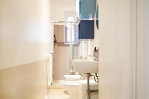 a bathroom with a toilet and a sink at Milan Retreats Porta Venezia in Milan +72 photos