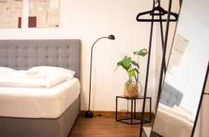 a bedroom with a bed and a plant on a table at meywohnen Prien am Chiemsee in Prien am Chiemsee