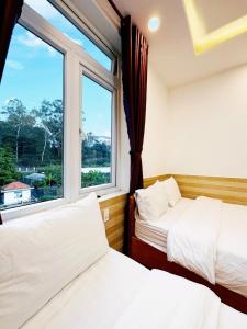 Postel nebo postele na pokoji v ubytování Hoa Chuông Villa Đà Lạt