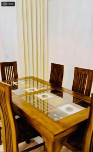 a wooden table with four chairs around it at Dikckwella Luna villa in Dickwella +27 photos