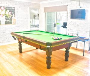 a billiard table in a living room with afits at Berkeley Waterfront - Family & Pet Paradise in Berkeley Vale