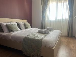 a bedroom with a bed with two towels on it at Selina Apart Transilvania in Braşov