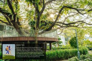 a sign in front of a building with a tree at The Somerset Hotel in Male City