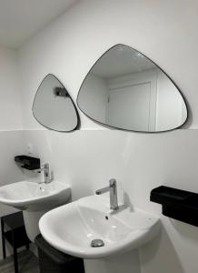 a bathroom with two sinks and a mirror on the wall at Espáciate in Nigrán +9 photos