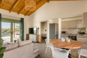a living room with a table and a couch at Athina Villa by Vintage Travel in Karavádhos