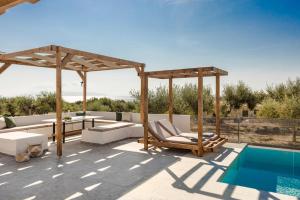 a patio with a swimming pool and a pavilion at Athina Villa by Vintage Travel in Karavádhos