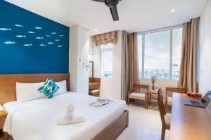 Postelja oz. postelje v sobi nastanitve Doha Central Bliss Danang Hotel by Haviland