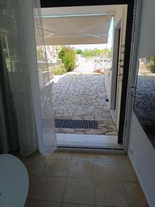 an open door to a patio with a stone walkway at Μαρία 4 in Káto Almirí