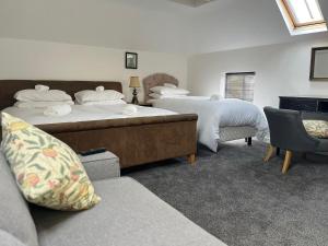 a hotel room with two beds and a couch at The Red Lion Swanage in Swanage +24 photos