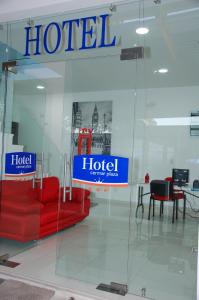 a hotel lobby with a red couch and a table at Hotel Cermar Plaza in La Barca