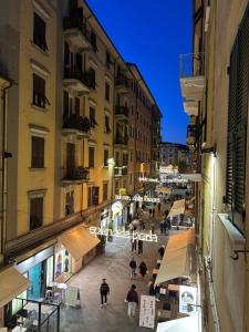 a group of people walking down a street at night at AM's Apartment in La Spezia