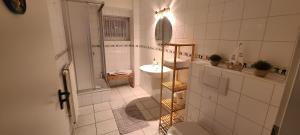 a white bathroom with a sink and a toilet at Strandhygge in Flensburg