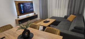 a living room with a couch and a table at Apartman Bear Vinkovci in Vinkovci