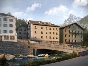 a bridge over a river with buildings and a mountain at San Bernardino Alpine Apartments in San Bernardino