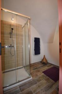 une douche avec une porte en verre dans une salle de bain dans l'établissement L'écrin du Pont du Gard, à Remoulins