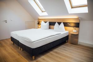 una camera da letto con un grande letto con cuscini bianchi di Palais a Erfurt Altre 9 foto