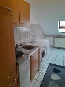 a kitchen with a sink and a washing machine at Ferienwohnung in Erftstadt in Erftstadt