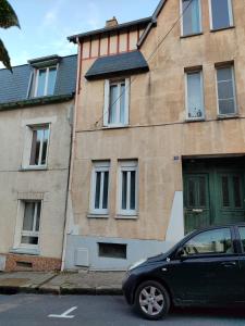 a black car parked in front of a building at Entire home - Centre Fécamp - 36 Elena in Fécamp +32 photos