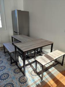 a wooden table with two benches and a refrigerator at Entire home - Centre Fécamp - 36 Elena in Fécamp