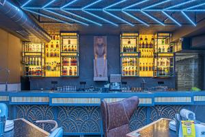 a bar in a restaurant with yellow lights at Echor Palm Bliss Riverside Resort & Spa Kasol in Kasol +68 photos