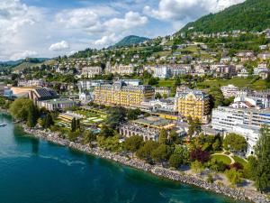 an aerial view of a city next to the water at Fairmont Le Montreux Palace in Montreux