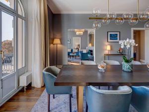 a dining room with a table and chairs at Fairmont Le Montreux Palace in Montreux