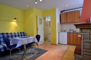 a kitchen with a table and chairs in a room at Domek gościnny Biel in Krościenko +12 photos