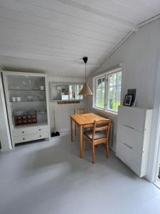 eine Küche mit einem Holztisch in einem Zimmer in der Unterkunft Cozy cottage in Stockholm Archipelago! in Muskö