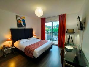 a bedroom with a bed and a window with a view at Adonis La Baule in La Baule +29 photos