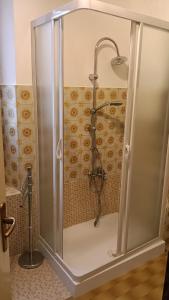 a shower with a glass door in a bathroom at Casa della Scalinata in Maccagno Superiore