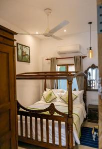 a bedroom with a bed and a ceiling fan at New! Mangalam house, Private plunge pool near beach in Trincomalee