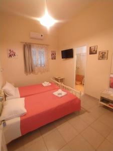 a hotel room with a bed and a television at Chris Apartments Corfu - Studio without kitchen in Alepou