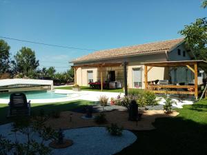 a house with a swimming pool in the yard at Laroclya in Lilhac