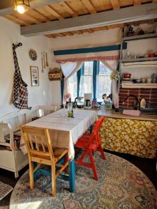 a kitchen with a table and chairs in a room at Complex Tradițional Casa din Vale Breb in Breb +38 photos