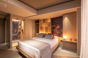 a bedroom with a large bed and a window at Dimora San Girolamo Luxury Apartments e Rooms in Marsala