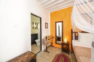 a bedroom with a bed and a bathroom at Shooting Star Boutique Hotel in Kiwengwa