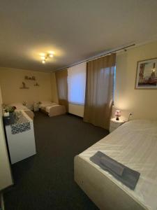 a hotel room with two beds and a window at Biała Dama in Łomża