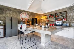 a kitchen with a large table and two chairs at Modern Joglo Villas in Canggu 5 Bedrooms in Kerobokan