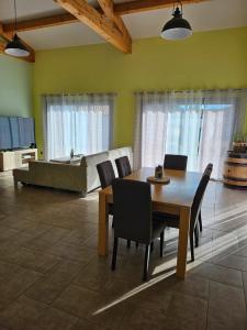 a dining room with a table and a couch at La Maison De Titou in Lazer