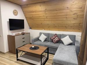 a living room with a couch and a table at Karapetyans Guest House in Stepʼanavan