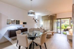 a dining room and living room with a table and chairs at Grand Baie Domaine des Alizes in Grand Baie