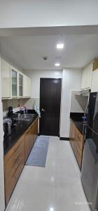 a kitchen with a black door and a black counter at Your HOME away from home in Manila