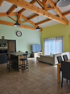 a large living room with a table and a couch at La Maison De Titou in Lazer