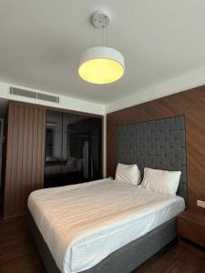 a bedroom with a large bed with a light above it at Grand sapphire resort Ötüken yeni iskele North Cyprus in İskele
