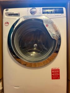 a washer and dryer with a sign on it at Amazing New Bed Stay in New Cross Goldsmiths in London