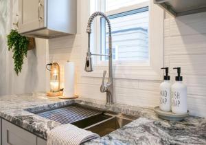 a kitchen counter with a sink and a window at Family Friendly 4 BR Home Close To Downtown CLE! in Cleveland +48 photos