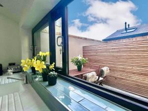 a balcony with a window with flowers on it at No 6 Bowling Green Yard in Knaresborough