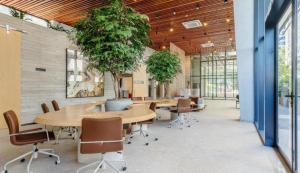 a conference room with tables and chairs and a tree at Alive Corredor da Vitória - Vista Mar in Salvador +20 photos